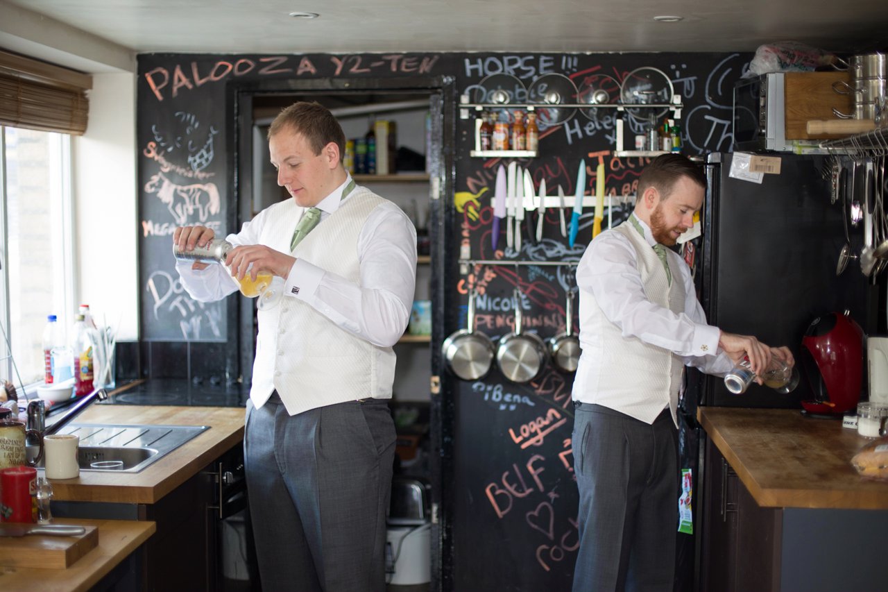 groom and best man having a beer before wedding