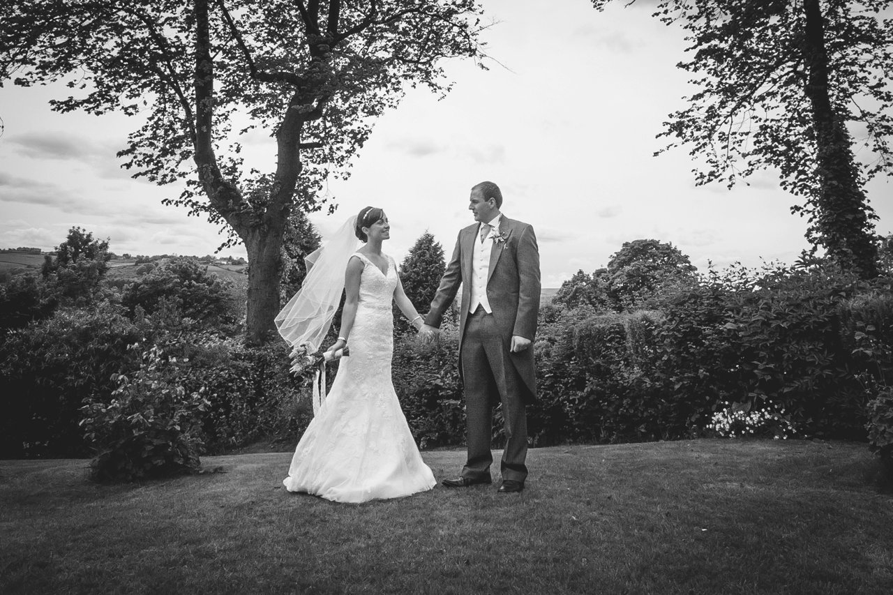 bride and groom formal photo in garden black and white