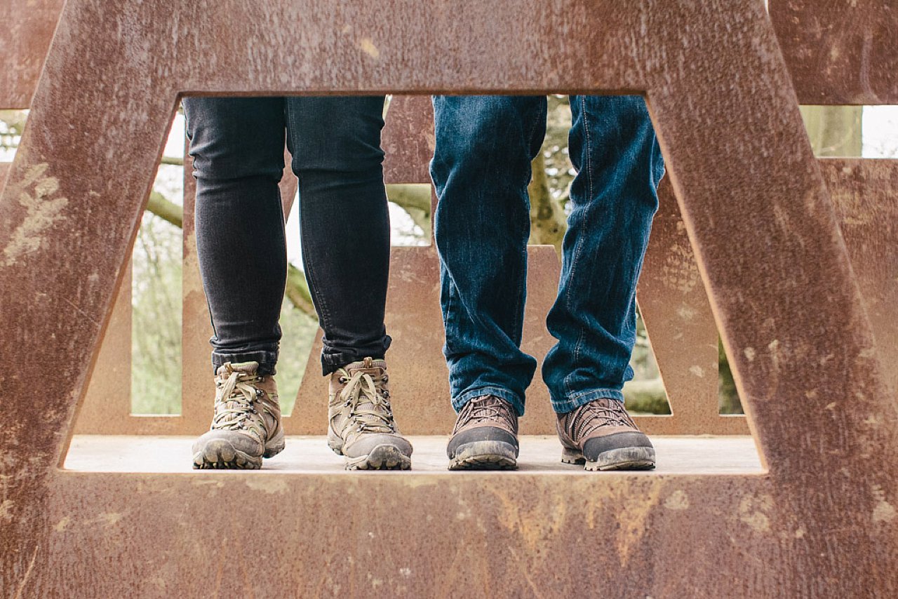 couple on rusting metal bridge