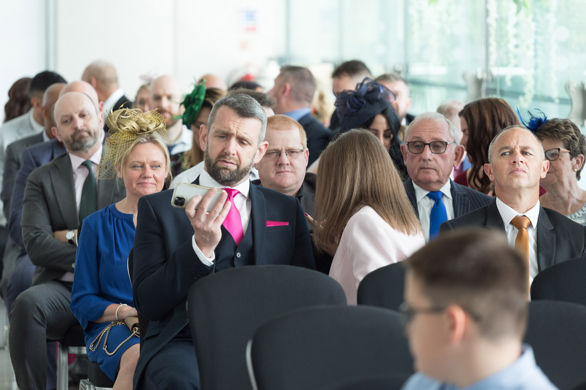 Wedding guest looking at phone